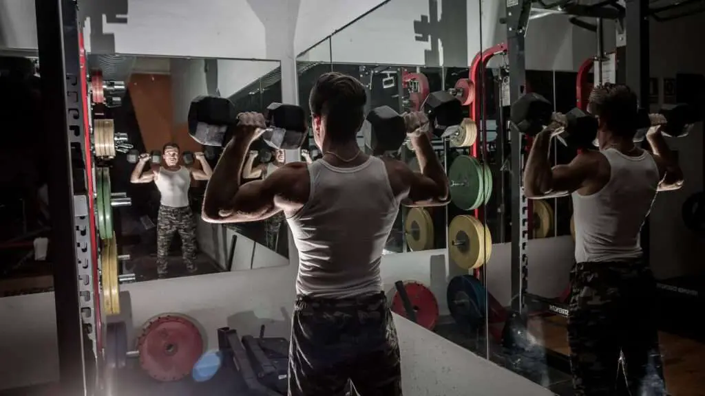 Man infront of a gym mirror